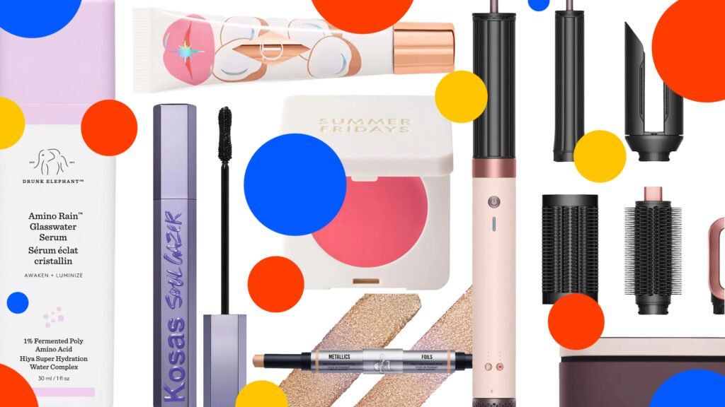 Product collage of Danessa Myricks BeautyColorfix Stix, Drunk Elephant Amino Rain™ Glasswater Serum, Kosas Soulgazer Lengthening Mascara, Summer Fridays Blush Butter Balm, Charlotte Tilbury Unreal Lips Healthy Glow Nectar Oil, Dyson Airwrap Co-Anda2x™ Multi-Styler on white background with red, yellow, and blue polka dots