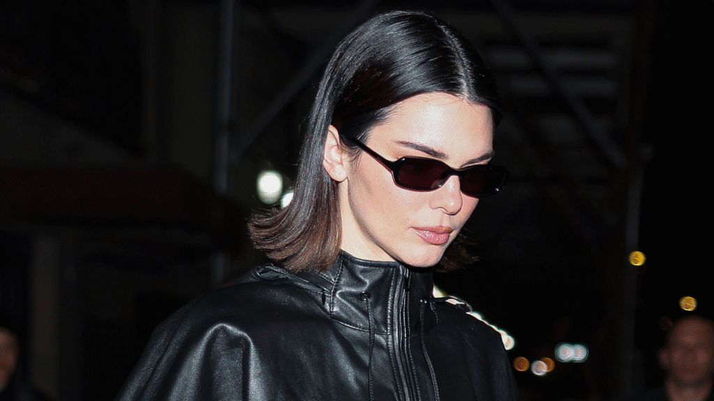 Kendall Jenner styled capri pants with a brown leather bag at Sushi Park
