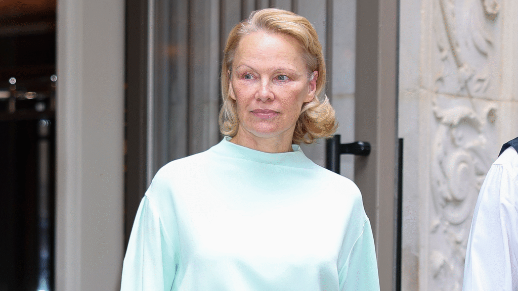 Pamela Anderson paired a monochromatic skirt set with Strathberry's Mosaic Bag.