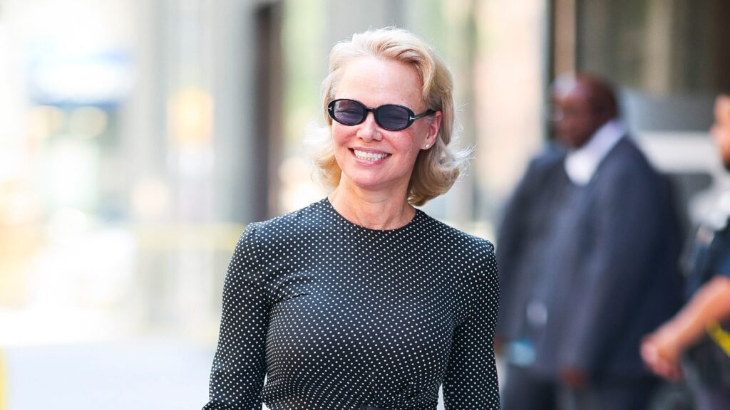 pamela anderson wearing sunglasses and a polka dot t-shirt