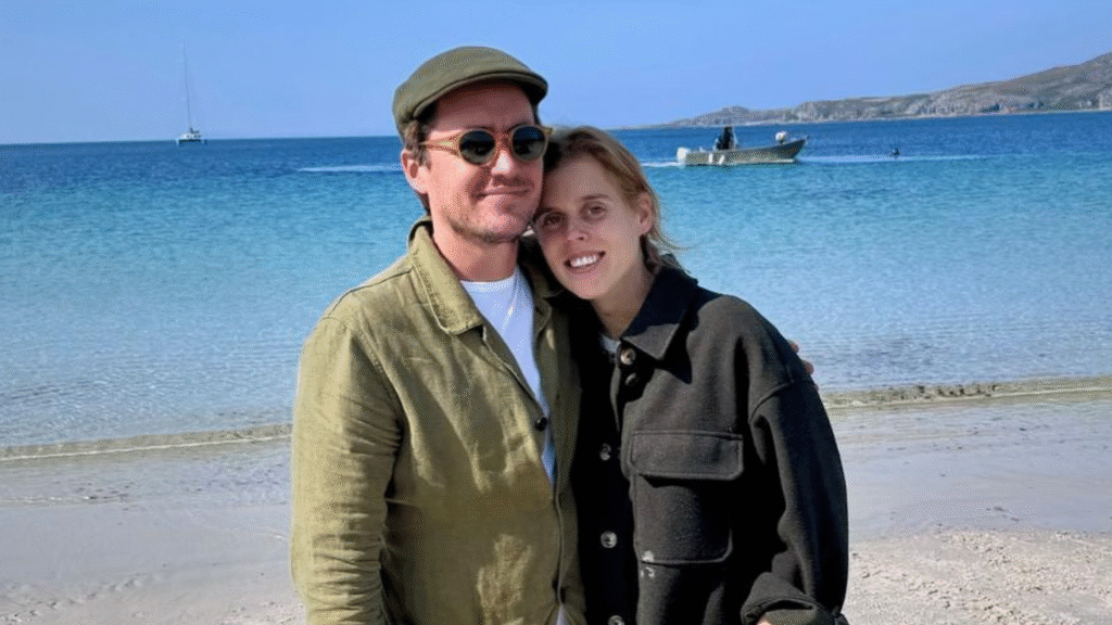 Princess Beatrice and Edoardo Mapelli Mozzi wearing green jackets on the beach and smiling
