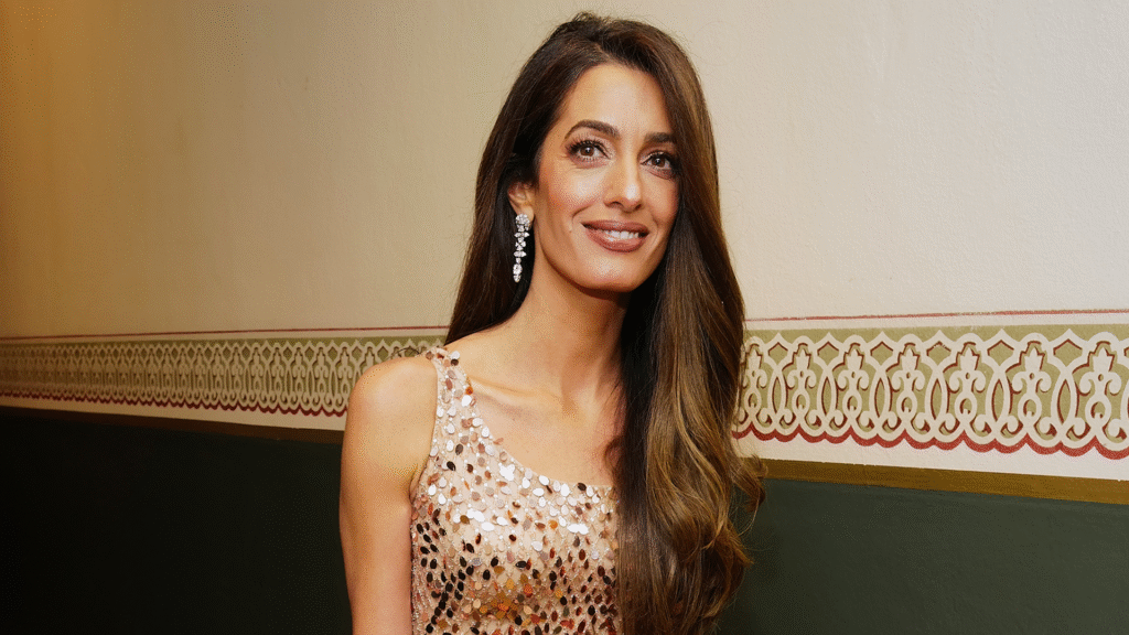 Amal Clooney Swaps Summer Whites for a Magenta Cowl-Neck Gown in Lake Como Amal Clooney Swaps Summer Whites for a Magenta Cowl-Neck Gown in Lake Como