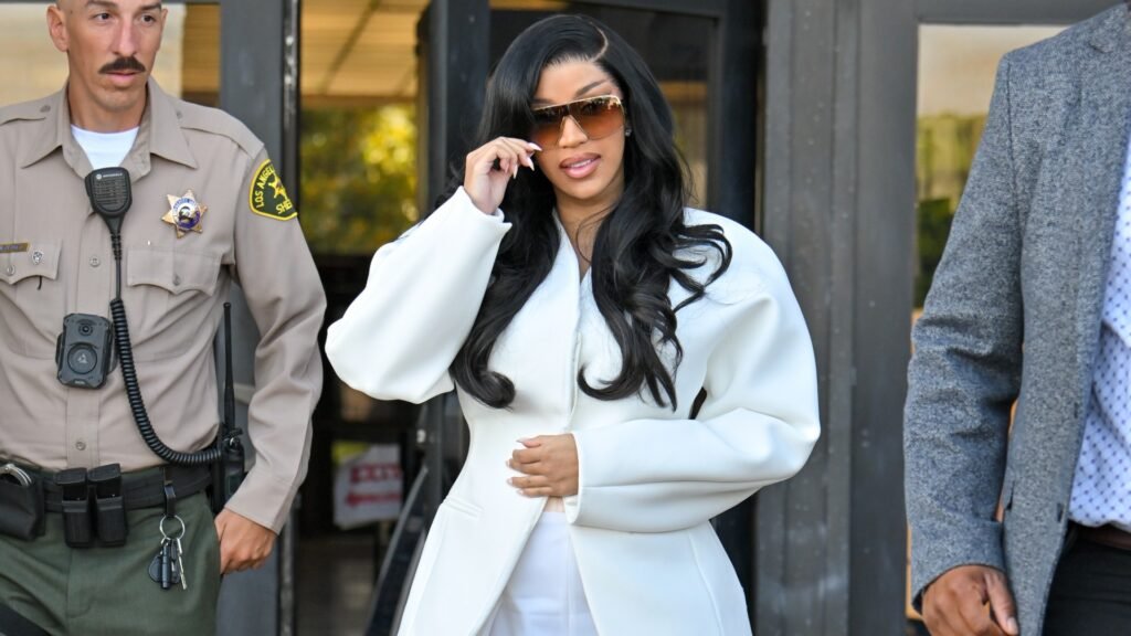 cardi b wearing a white suit and black hair