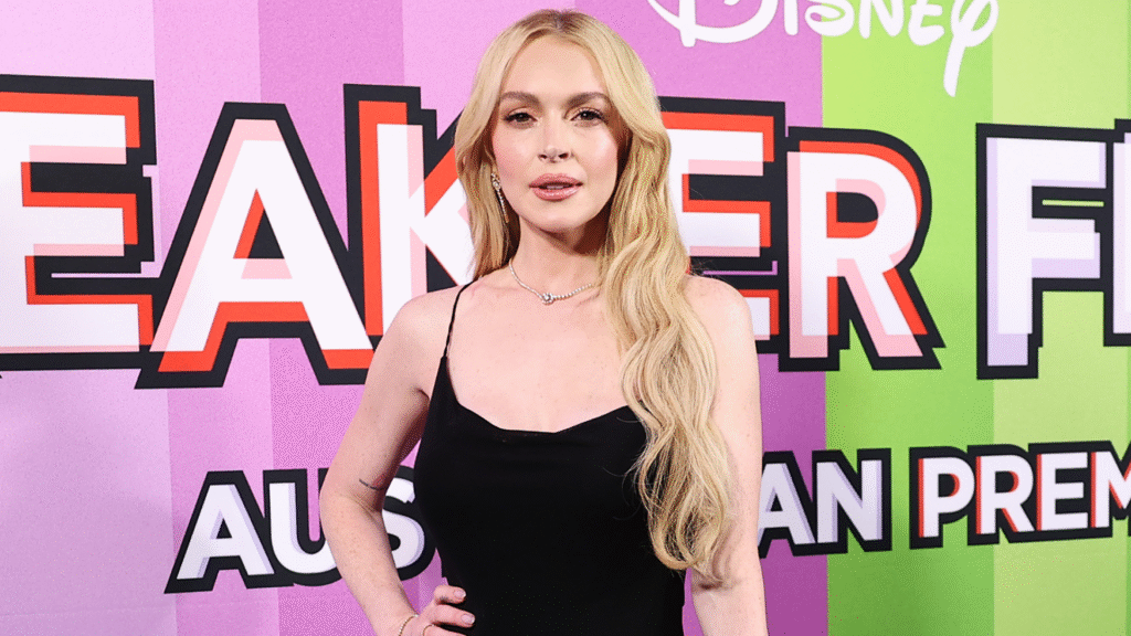 Lindsay Lohan attended a Freakier Friday premiere in Australia wearing a Saint Laurent little black dress and a gold fortune cookie clutch