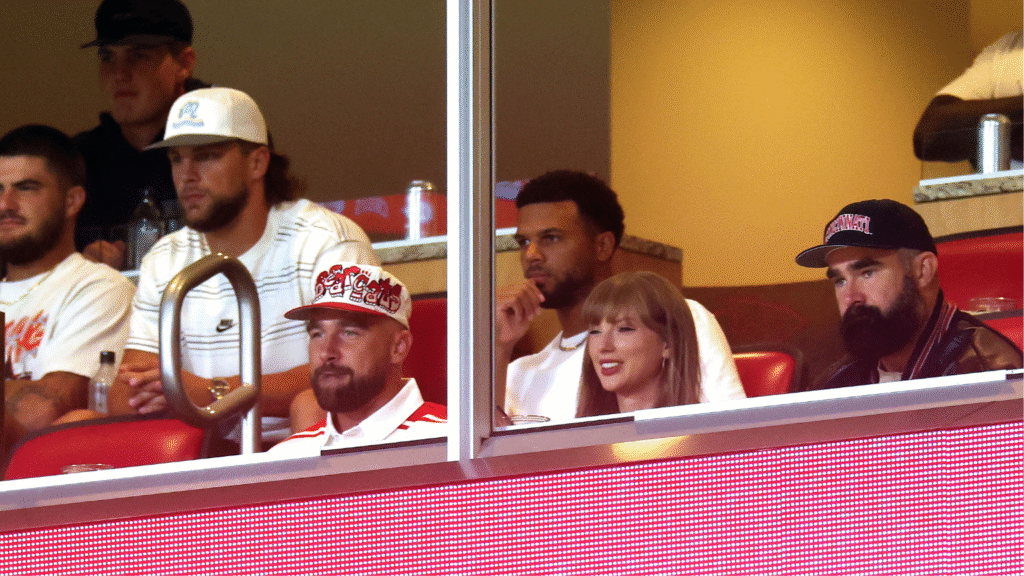 taylor swift and travis kelce in a football stadium box