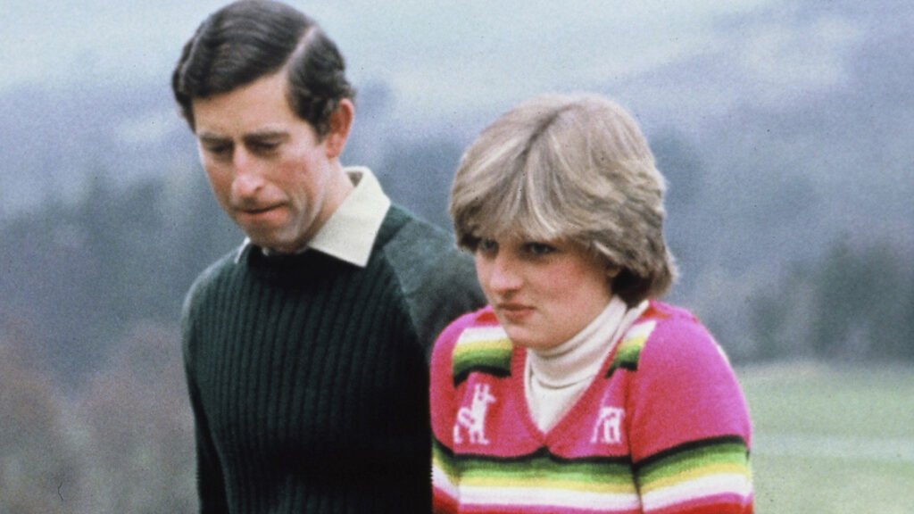 Prince Charles and Princess Diana wear sweaters and pose in the countryside