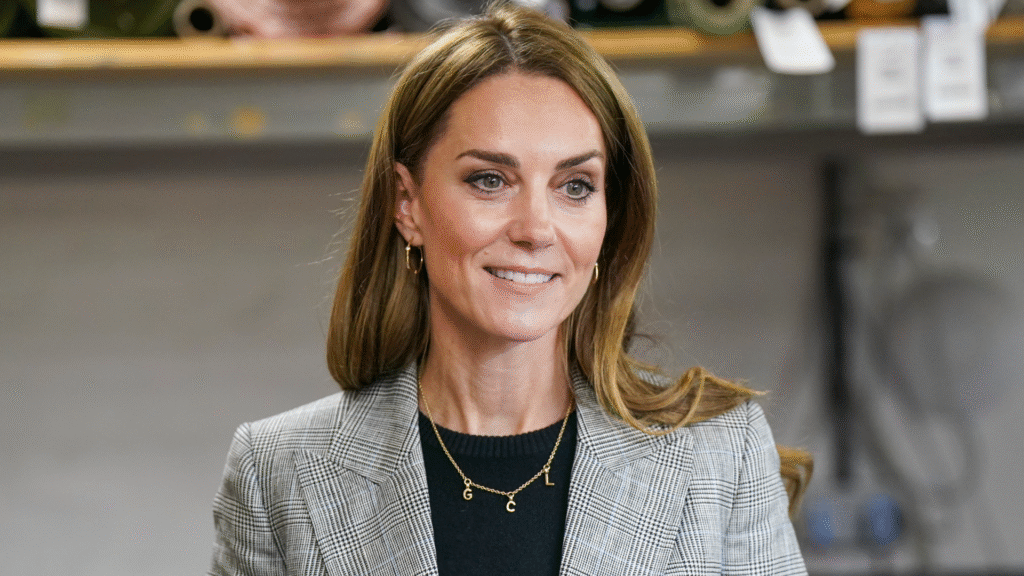 Kate Middleton wearing a gray suit and smiling
